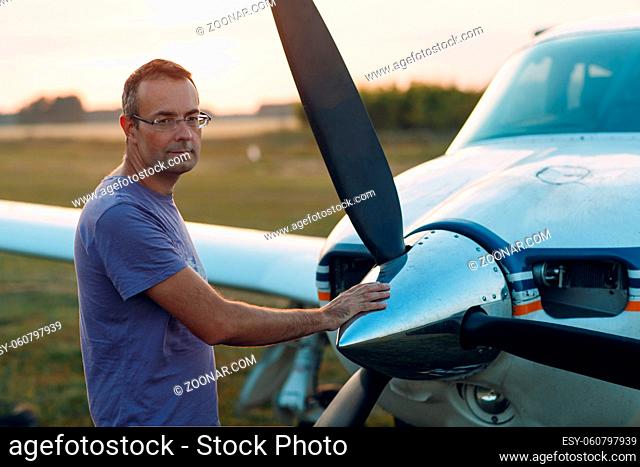 RUSSIA, MOSCOW - AUGUST 1, 2020: Pilot man standing next to a small private airplane