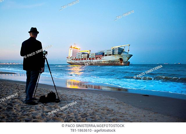 Spain, Valencia, El Saler, Photographer and Boat on Beach