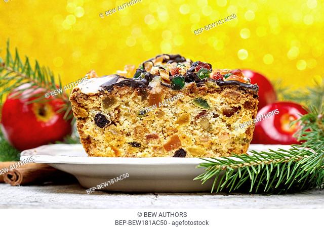 Fruitcake with dried fruits and nuts in christmas setting