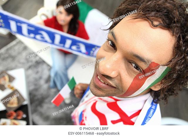 Two Italy fans watching match at home
