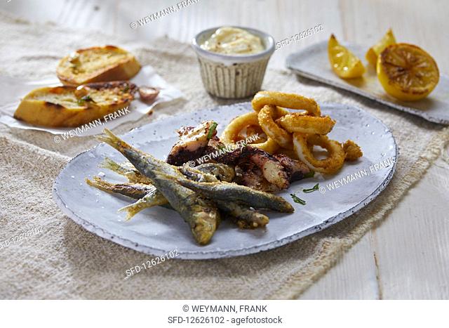 A seafood platter with calamari, pulpo and sardines (Italy)