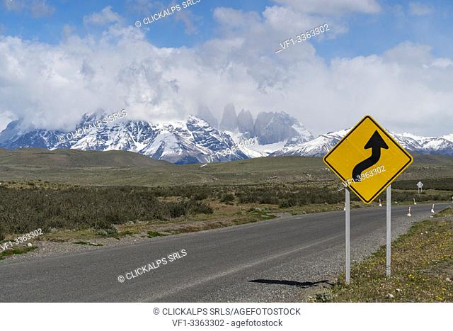 Road sign and Paine Towers in the background in summer. Torres del Paine National Park, Ultima Esperanza province, Magallanes region, Chile