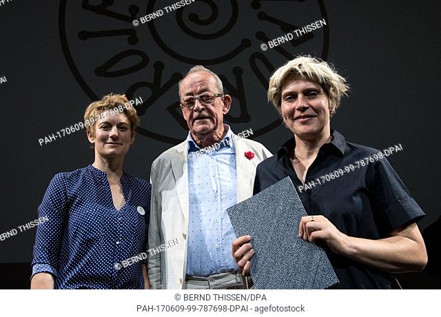 The art director, Kasper Koenig (C), stands next to curators Britta Peters (R) and Marianne Wagner during a press conference on the opening of the 'sculpture...