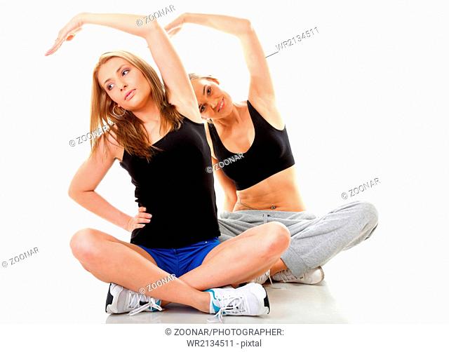 Two women doing fitness exercise isolated