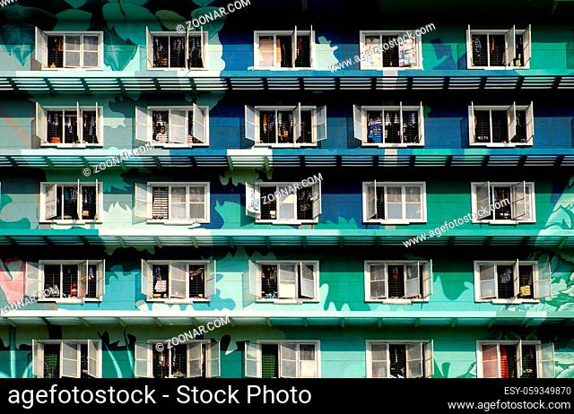 Group of windows at facade building in green on day, this highrise building is student dormitory at Ho Chi Minh city, Vietnam