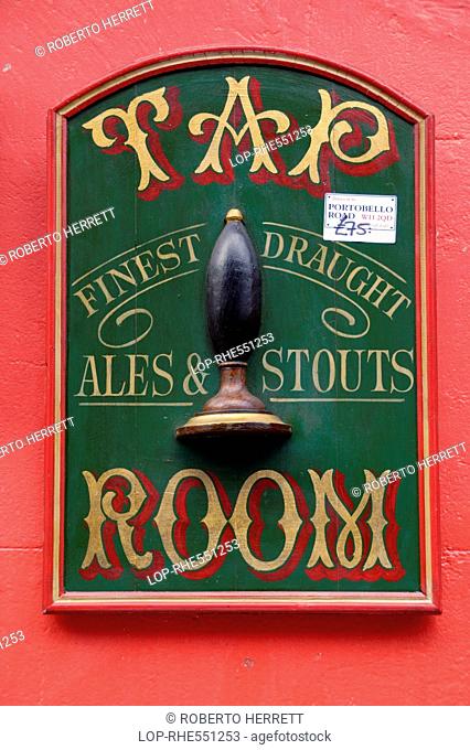 An antique tap room sign for sale in Portobello market