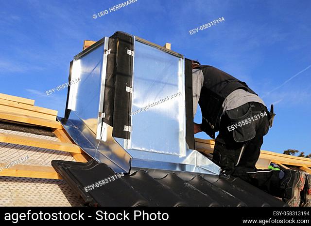 Roofer working on exterior chimney cladding