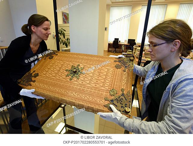 Librarians Ludmila Netusilova, left, and Martina Vodakova adjust facsimile of the Devil's Bible (Codex Gigas) exhibited Municipal Museum of Usti nad Labem