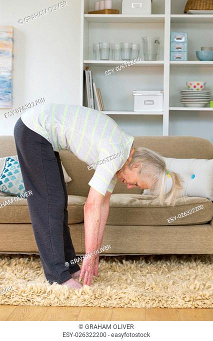 Senior woman doing exercise in her home