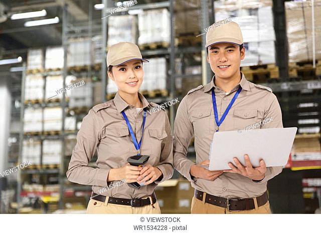 Oriental logistics personnel working in the warehouse