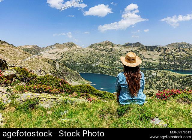 Woman with straw hat in the Néouvielle nature reserve in the Pyrenees
