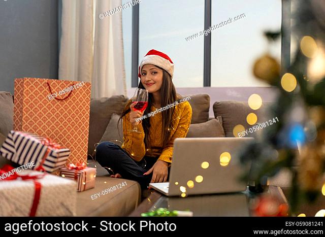 Happy Woman Making Video Call During Christmas wine party Celebration holding wine glass