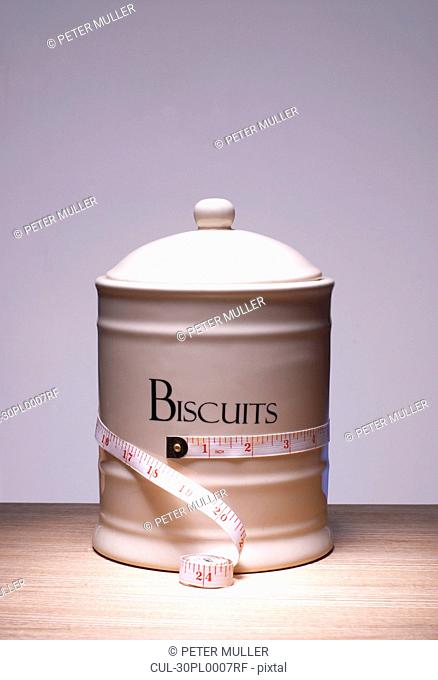 Biscuit jar with tape measure around it