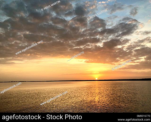 Sunset with clouds, over the shoreline near Darwin City, in the Northern Territory of Australia