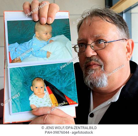 Grandfather of the murdered boy Jason, Gerhard Pappe, holds a photo of his grandson at the regional court in Magdeburg,  Germany, 29 May 2013