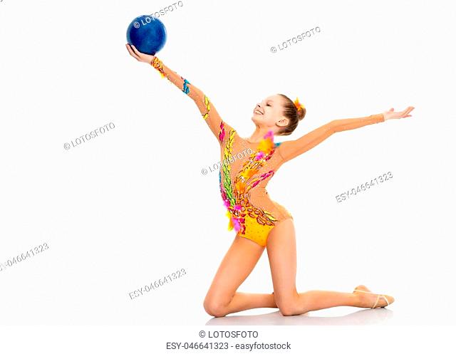 The little girl is catching the ball. The concept of relaxation, fitness and gymnastics. Isolated on white background