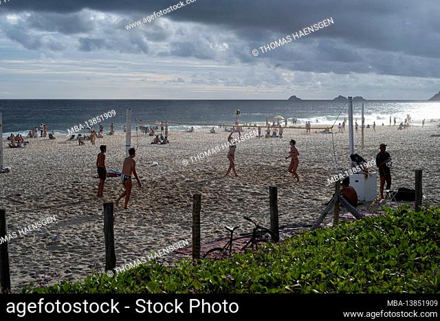 Young Brazilians play a game of futevôlei (footvolley), a sport that combines football/soccer and volleyball, on the beach in Leblon