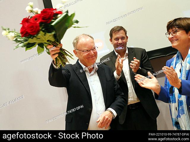 10 October 2022, Berlin: Lars Klingbeil and Sakia Esken (both SPD chairwomen), congratulate Stephan Weil (l), Minister President in Lower Saxony after the state...
