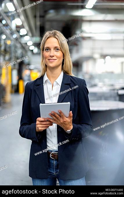 Female professional with digital tablet at industry