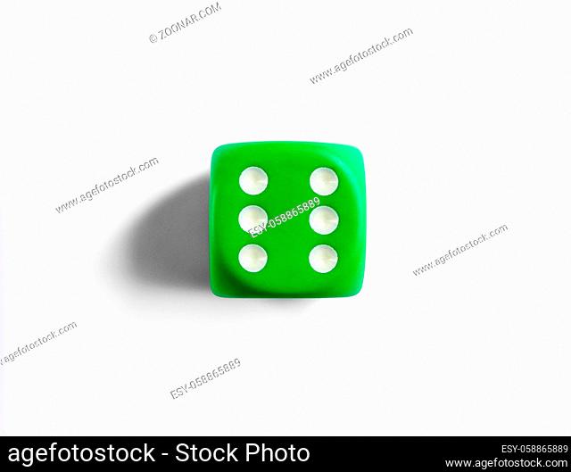 Number 6 on green dice. White background. Top view