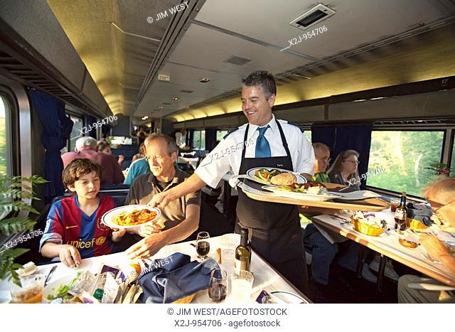Aboard the California Zephyr, Iowa - A waiter serves dinner in a dining car on a transcontinental Amtrak train
