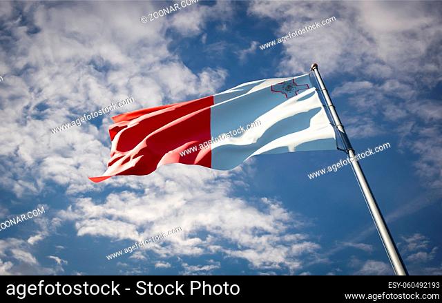 Beautiful national state flag of Malta fluttering at sky background. Low angle close-up Malta flag 3D artwork