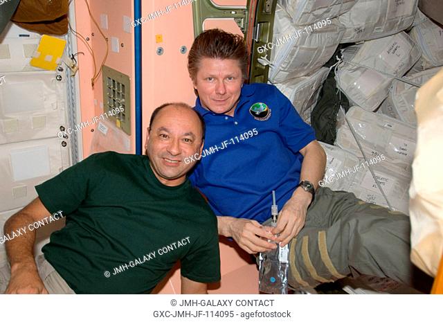 Astronaut Mark Polansky (left) and Russian Federal Space Agency cosmonaut Gennady Padalka take a break from a busy agenda onboard the International Space...