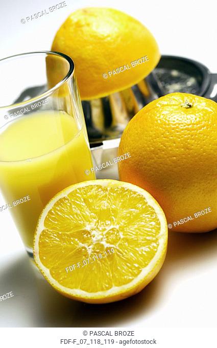 Close-up of oranges with a glass of juice