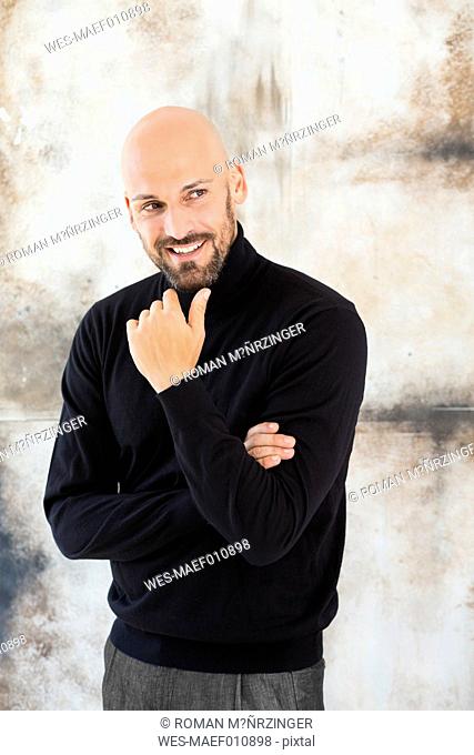 Portrait of smiling man wearing black turtleneck
