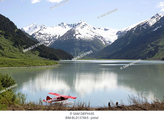 Seaplane docked in still lake in mountain landscape, Anchorage, Alaska, Denali National Park, United States