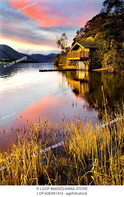 Early morning light falls on a boathouse near Pooley Bridge on the shores of Ullswater