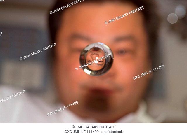 Astronaut Leroy Chiao, Expedition 10 commander and NASA ISS science officer, watches a water bubble float between him and the camera