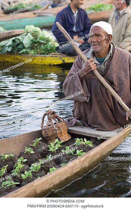 Man selling plants in a boat, Dal Lake, Srinagar, Jammu And Kashmir, India