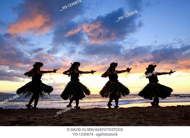 Silhouette of hula dancers at sunset at Palauea Beach, Maui, Hawaii