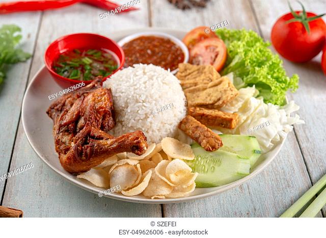 Nasi lemak kukus with fried drumstick, popular traditional Malaysian local food