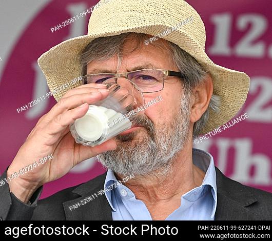 11 June 2022, Brandenburg, Angermünde: Axel Vogel (Bündnis 90/Die Grünen), Minister of the Environment of Brandenburg, drinks a glass of milk at the opening of...