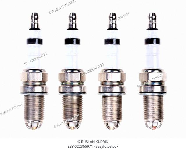 Four spark plugs. Isolated on white
