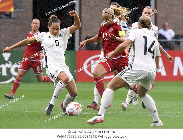 Germany's Babett Peter (l) and Denmark's Pernille Harder (c) in action during the UEFA Women's EURO quarterfinals soccer match between Germany and Denmark at...