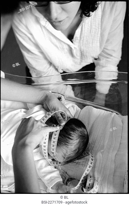 Newborn baby boy. Measurement of the head circumference