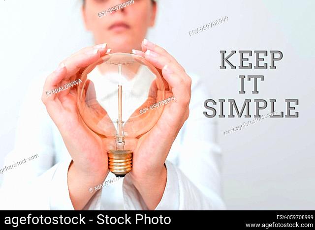 Handwriting text Keep It Simple, Conceptual photo ask something easy understand not go into too much detail Lady in outfit holding lamp with two hands...