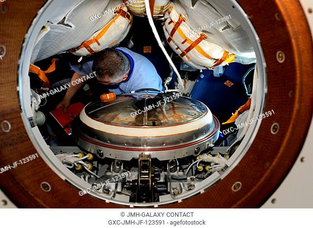 Russian cosmonaut Fyodor Yurchikhin, Expedition 24 flight engineer, works in Soyuz TMA-19 spacecraft while docked to the Zvezda Service Module's aft port of the...