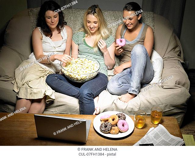 Three young women watching movie