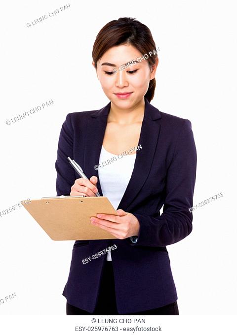 Asian Young Businesswoman take note on clipboard