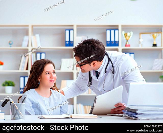 Female patient visiting male doctor for regular check-up in hospital clinic