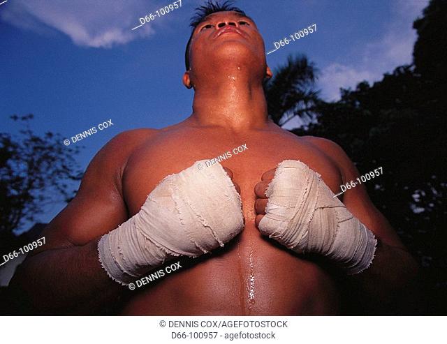 Man's wrapped hands in Muay Thai training camp, Bangkok. Thailand