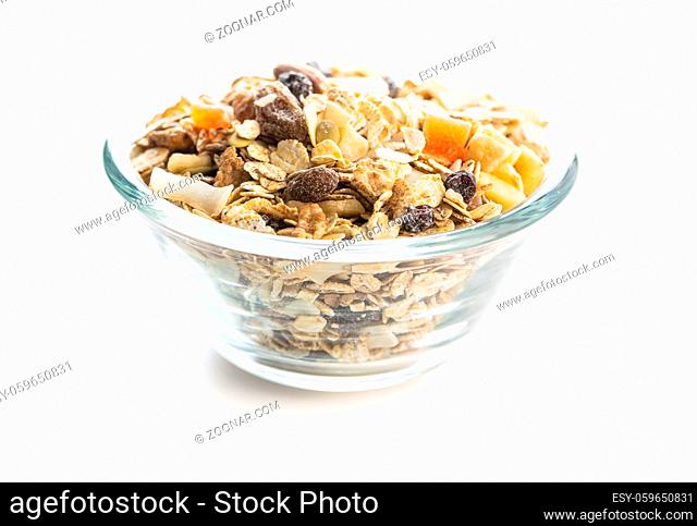 Beakfast cereals in bowl. Healthy muesli with oat flakes, nuts and raisins isolated on white background