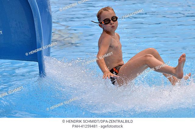 A boy slides into the water in the bath of Rebesgruen, Germany, 24 July 2013. This weekend the 17th German water sliding championship will take place in the...
