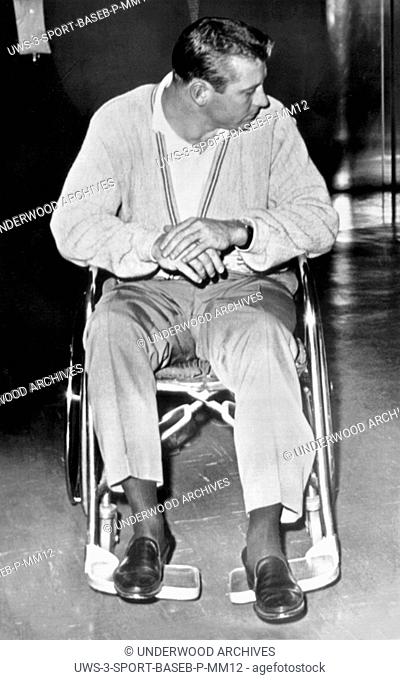 New York, New York: May 19, 1962 New York Yankee baseball star Mickey Mantle in a wheelchair at Lenox Hil Hospital after tearing a thigh muscle while running...