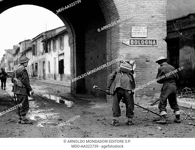 Mine clearing of the streets of Faenza. New Zealander soldiers with a metal detector mine clearing a street of Faenza, 23rd December 1944