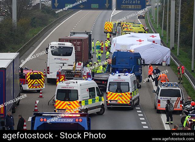 Fire fighters and rescue workers pictured at the site of a collision between a bus (coach) and a truck on the E17 highway in Destelbergen, near Ghent